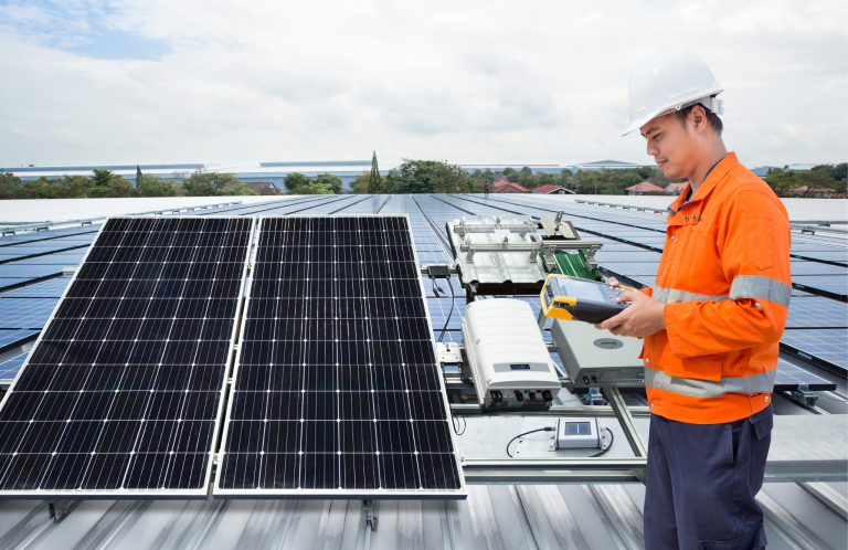 worker maintaining solar panels