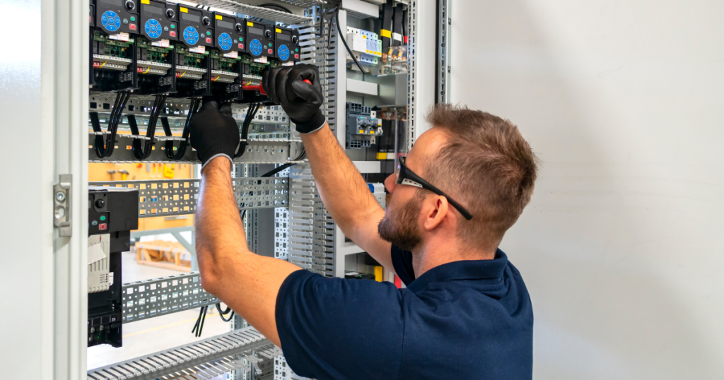 electrician installing surge protector in an electrical panel