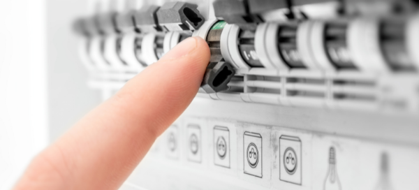 Prescott Valley electrician from Assurance Electrical resetting a fuse breaker switch