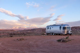 Travel trailer parked in the desert, showing need for safe electrical hookup for an RV at home