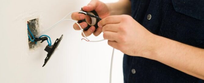 Homeowner checking outlet wiring during a home wiring safety inspection in Prescott Valley