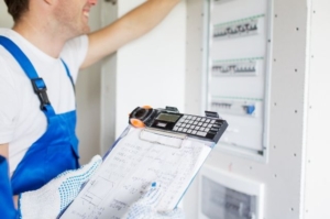 Prescott Valley electrician from Assurance Electrical inspecting an electrical panel for a manual transfer switch installation