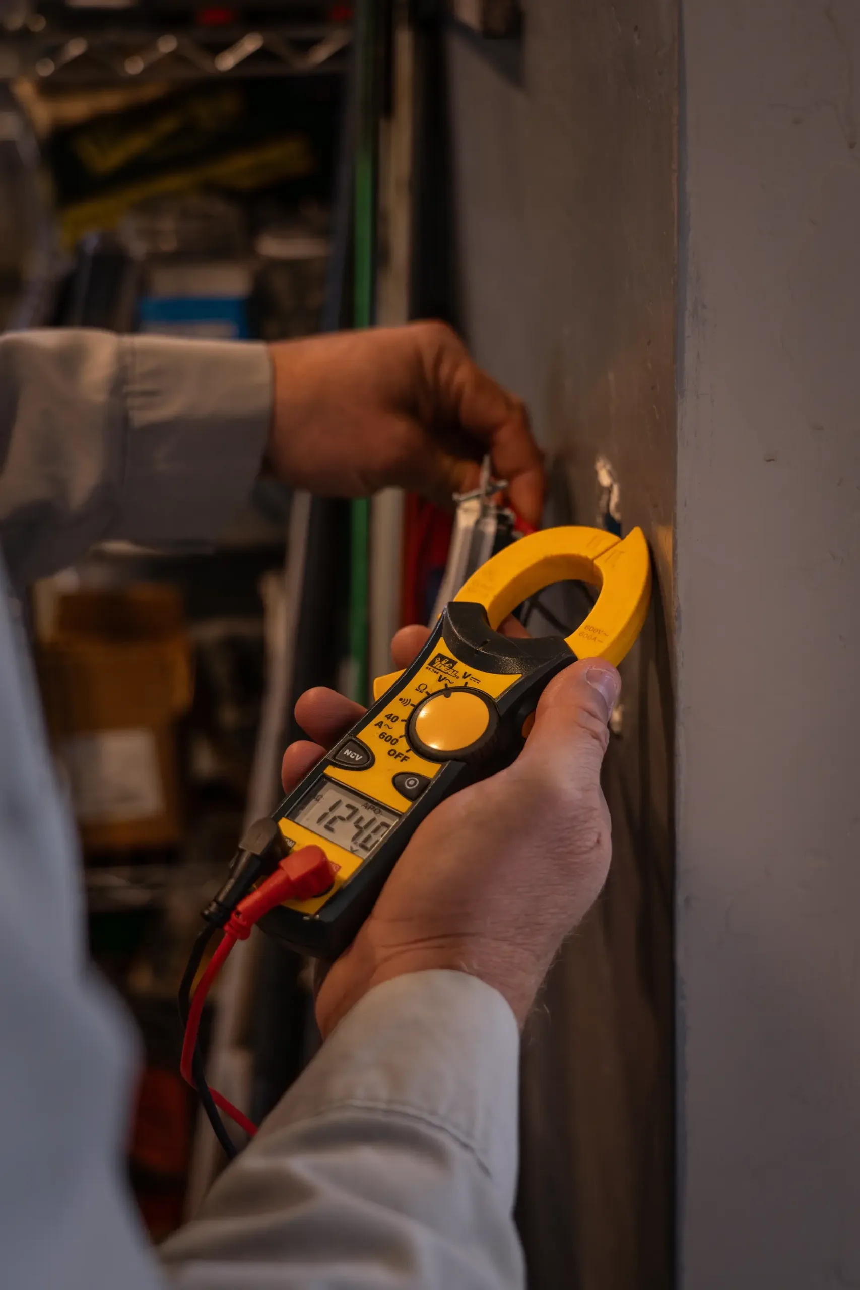 Licensed Electrician of Assurance Electrical Services inspecting an outdoor electrical panel in Prescott Valley