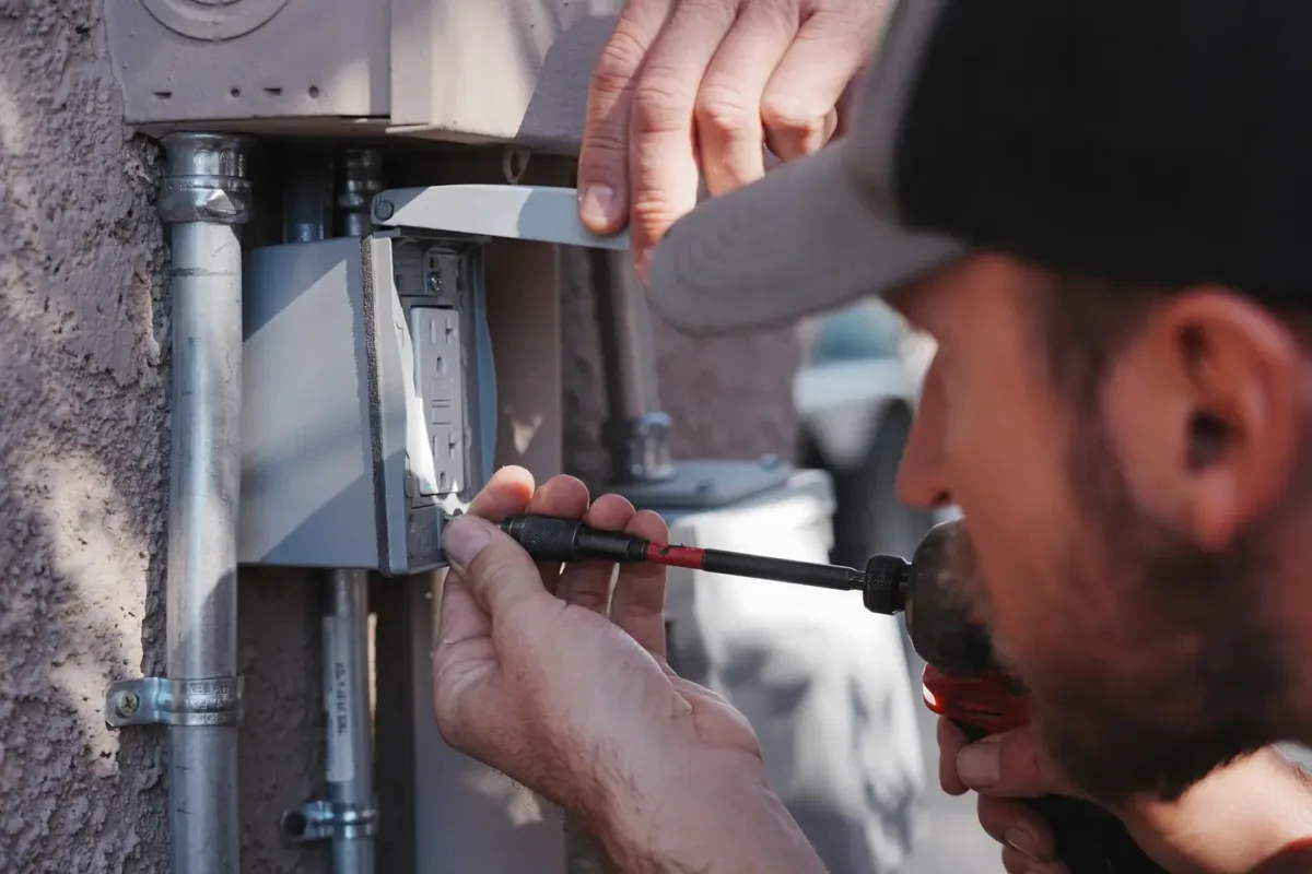 Assurance electrician testing exterior GFCI outlet during home safety inspection in Prescott Valley