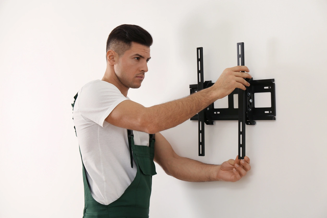 Prescott Valley electrician installing TV mount and power setup for safe electrical services and clean wall mounting
