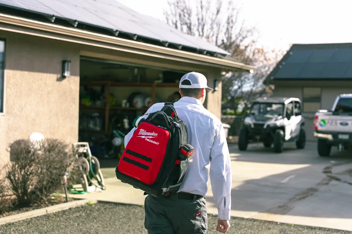 Electrician arrives at the house with a tool bag to inspect electrical problems in older homes