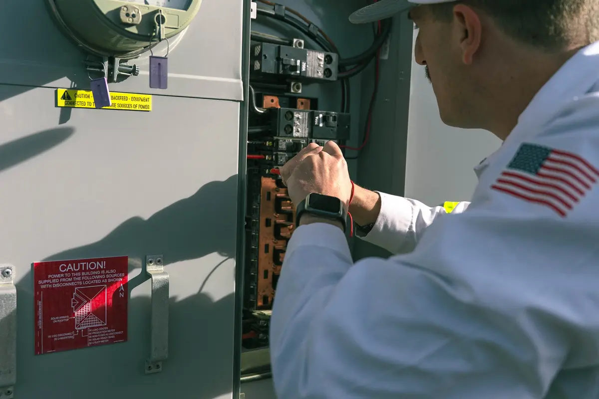 The technician inspects the industrial control cabinet and shows the types of electrical panel boards on site.